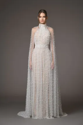 Halter neck bridal gown featuring a cape adorned with cascading pearls