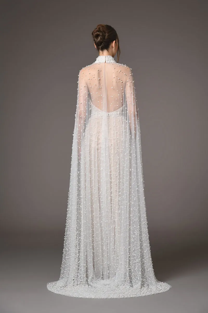 Halter neck bridal gown featuring a cape adorned with cascading pearls