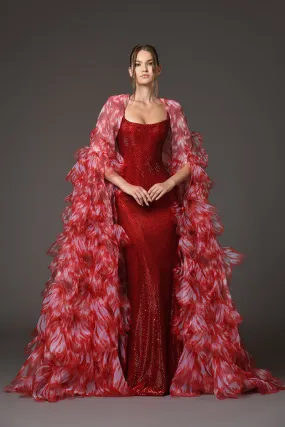 Red embellished corseted dress with a dramatic cape of overflowing laser-cut organza flower petals