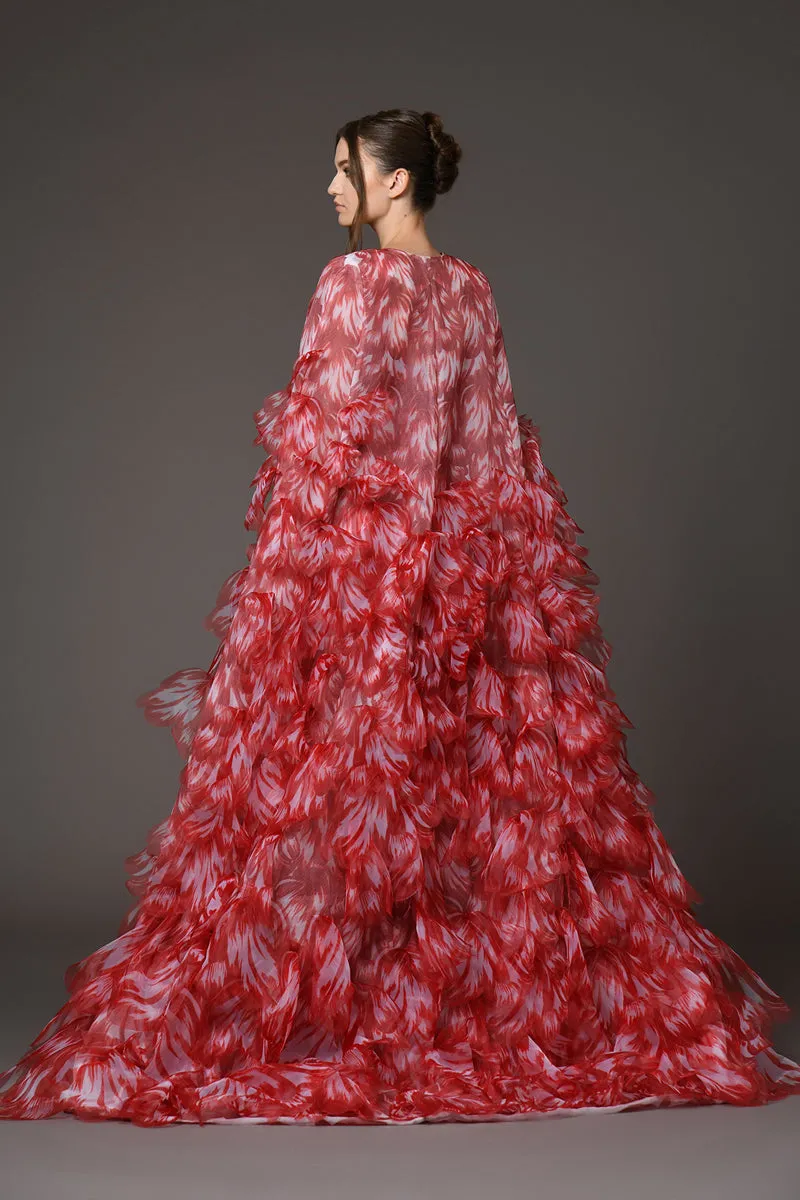 Red embellished corseted dress with a dramatic cape of overflowing laser-cut organza flower petals